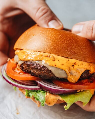 Holding a lamb burger with hands